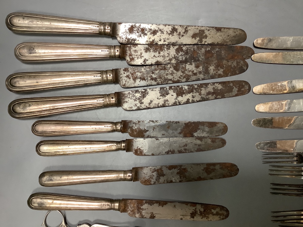 Four George IV silver handled table knives and four similar desert knives and a quantity of silver handled fruit knives and forks and two silver butter knives.